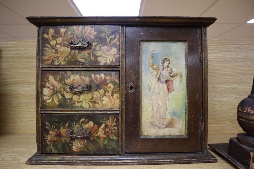 A painted wood hanging wall cupboard and a fret carved and grained wood pediment, 124cm